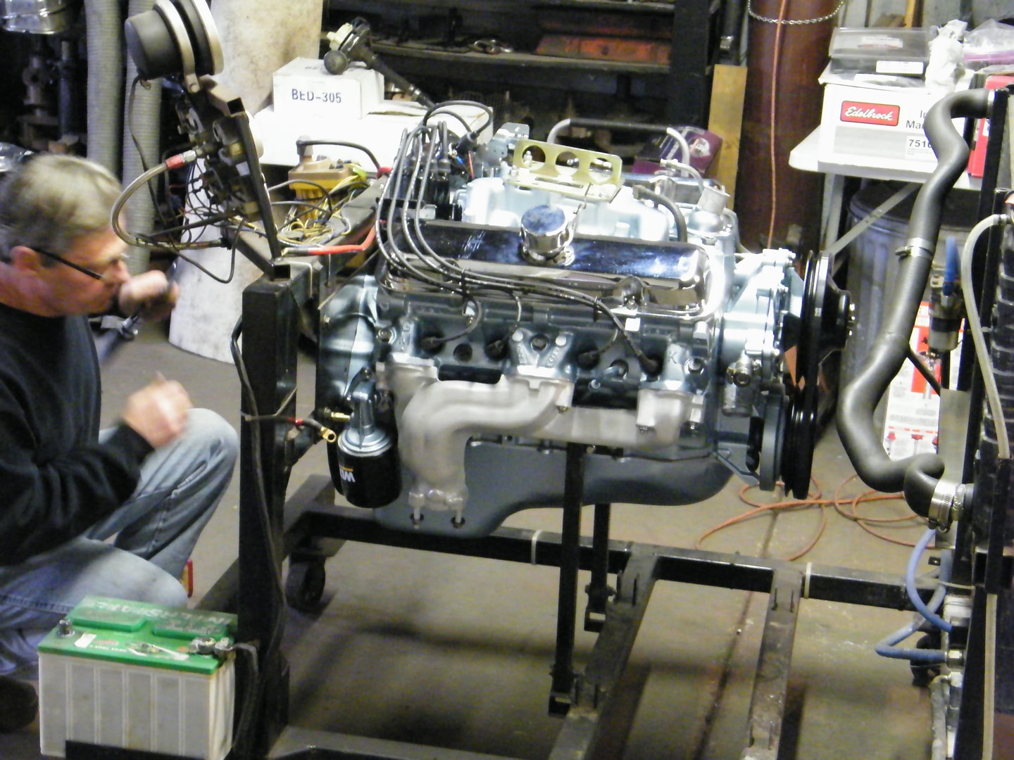 Mechanic testing engine on dynamometer