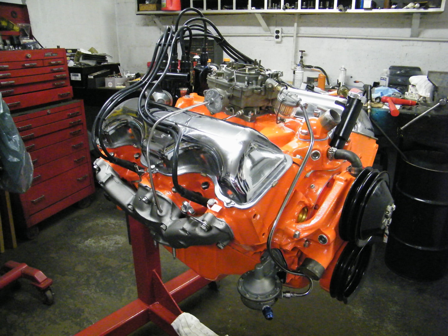 Restored orange engine on workshop stand